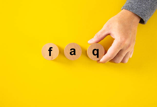 istock Hand holding wooden cube blocks with FAQ text 1460439043