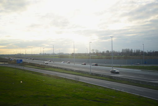 Blankenberge, West-Flanders, Belgium - January 28, 2023: motion blur view from a riding car on the highway Expressweg N31 Saturday late afternoon