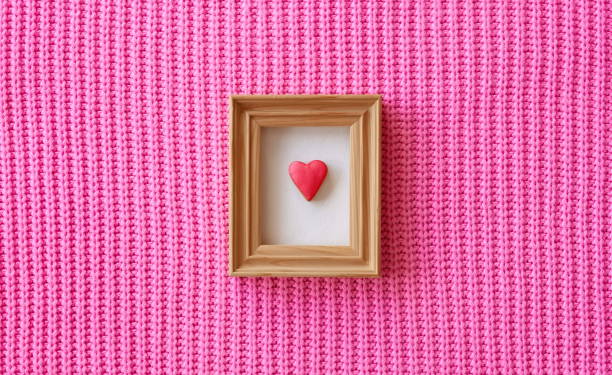 istock Gingerbread heart in a frame. Cute knitted background. 1460442715