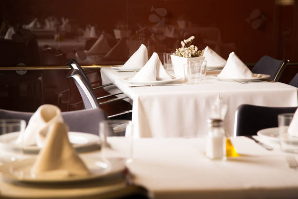 istock Elegant restaurant table with cutlery, crockery and glasses. 1460446233