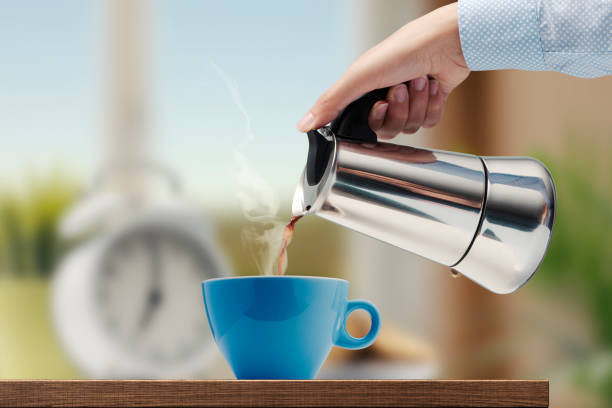 istock Woman pouring hot coffee in a cup 1460446257