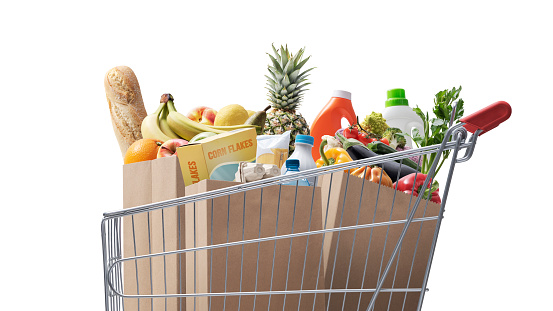 Shopping cart full of fresh groceries, grocery shopping concept Isolated on white background