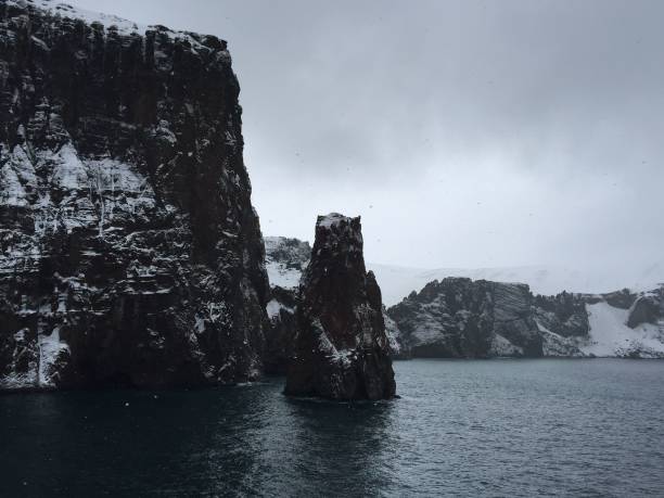 istock Beautiful seascape with snow-covered cliffs in Antarctica 1460446747