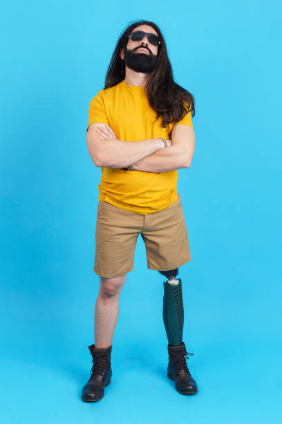 istock Man with sunglasses standing with a prosthetic leg 1460447007