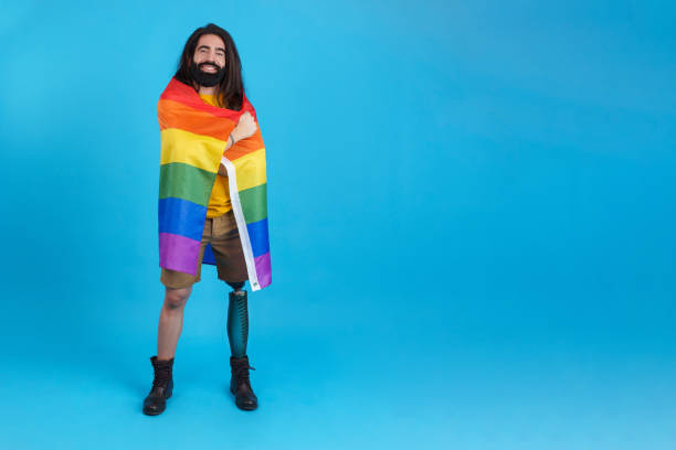 istock Man with a prosthetic leg wrapped in a lgbt flag 1460447034