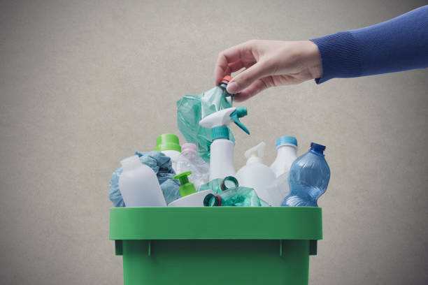 istock Woman putting plastic in the recycling bin 1460447830