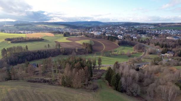 istock Drone shot over green fields with autumn trees at countryside on a sunny day 1460448044