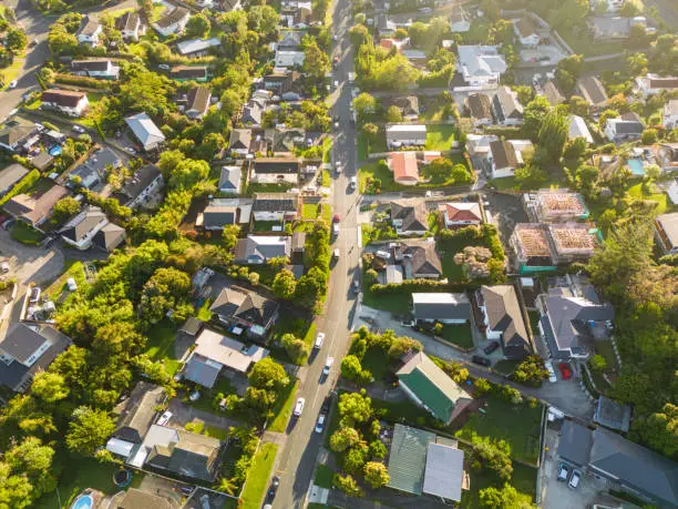 Drone view of a suburban with transportation on roads and neighbour houses.