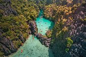 Aerial view of tourists entering the Small Lagoon in Maniloc Island, El Nido, Palawan, Philippines