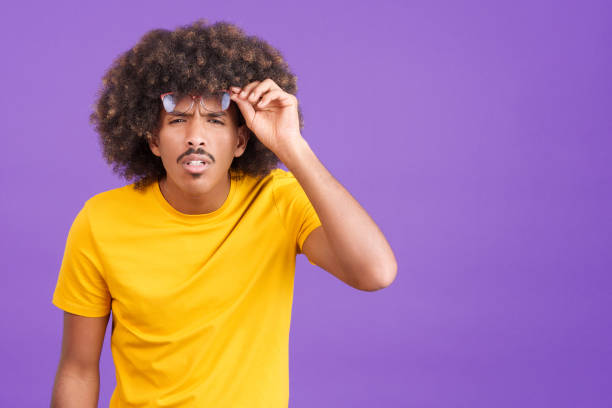 istock African man taking off her glasses to see far away 1460449037