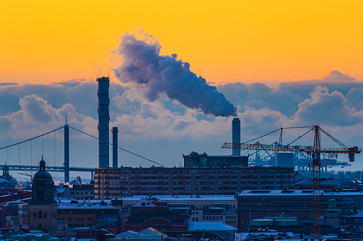 Gothenburg, Sweden - december 11 2022: Steam rising from a heating plant on a cold afternoon.