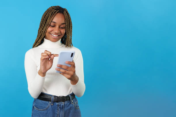 istock African smiling woman using the mobile phone 1460449470