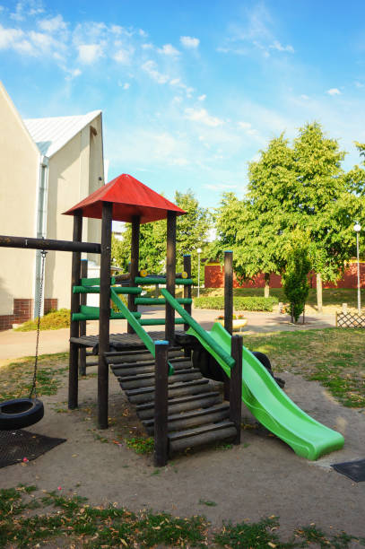 istock Vertical shot of an empty slide at a playground under a blue cloudy sky on a sunny day 1460449932