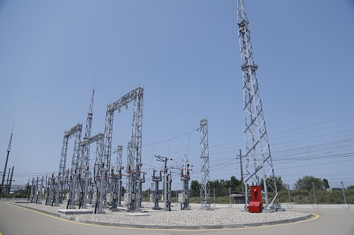 An aerial view of electrical substation surrounded by metal towers