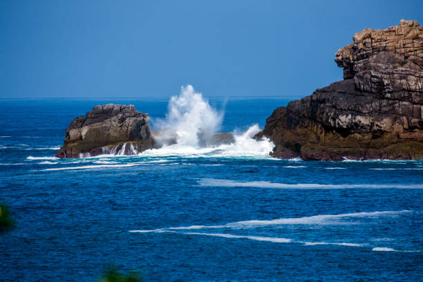 Sea waves crashing and bouncing on the rocks at Bryher, Scilly Isles, UK