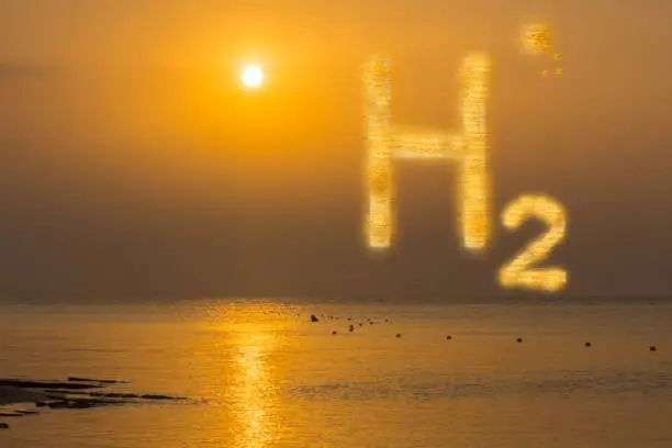 Photo of 3D illustration pure energy glowing orange h2 hydrogen and wam sun on the sky with reflections during sunset