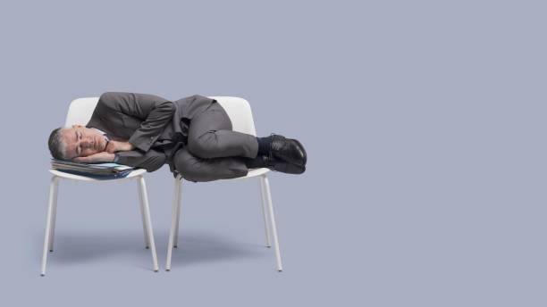 istock Exhausted businessman sleeping on chairs 1460452935