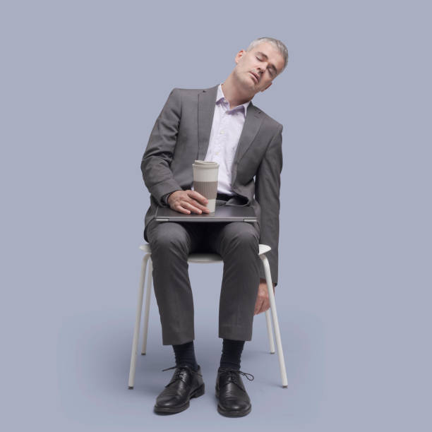 Businessman sitting on a chair and sleeping Lazy tired businessman sitting on a chair and falling asleep man sleeping chair stock pictures, royalty-free photos & images