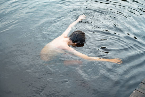 istock High angle view of a person swimming in a pool 1460454822