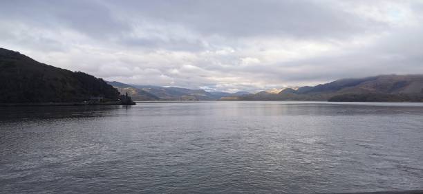 istock Tranquil view of a lake surrounded by mountains on a cloudy day 1460455235
