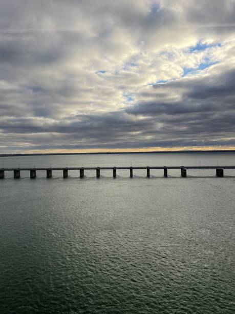 istock Long bridge in the ocean under the dark clouds 1460456231