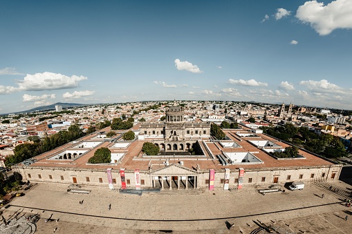 Guadalajara, Mexico – October 09, 2022: A drone view of the Hospicio Cabanas in Guadalajara, Jalisco, Mexico in the background of small houses