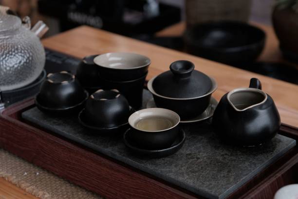 istock Closeup of matte black tea set on a wooden table 1460458903