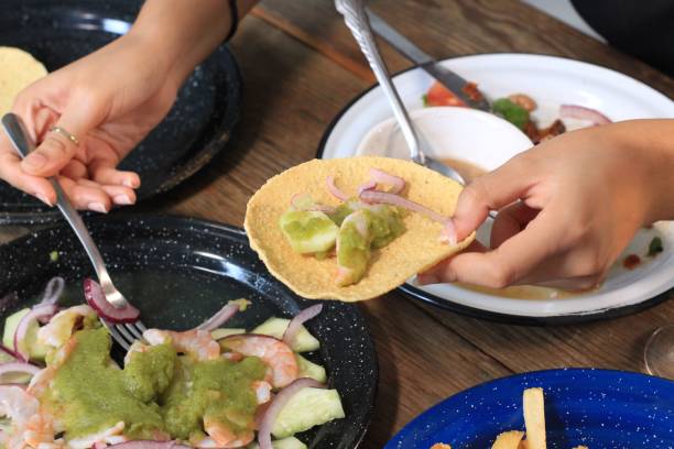 istock Female hand putting ingredients on bread to eat guacamole 1460458968