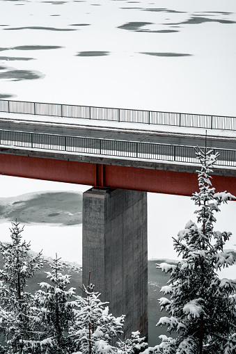 A vertical shot of a bridge on a winter day