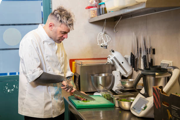istock Chef chopping vegetables for a pancake steak tartare with cheese in a kitchen 1460459125