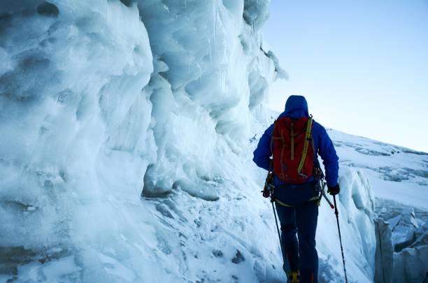 istock Hiker climbing a snowy mountains with special gear and a backpack during the daytime 1460459915