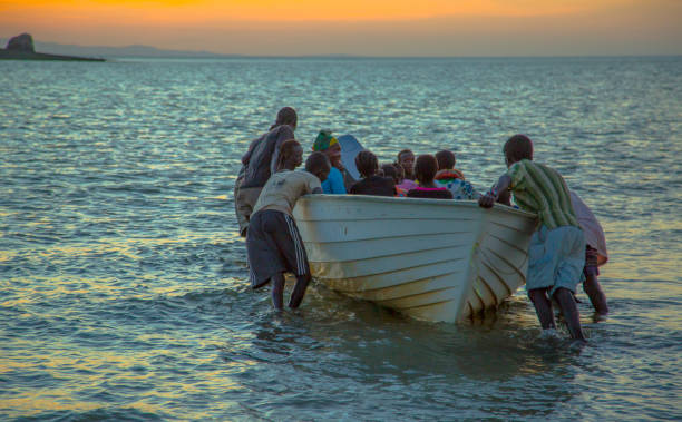 Loiyangalani, Kenya – April 12, 2018: Catching a boating ride to the Island on Lake Turkana before nightfall