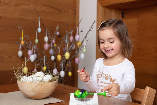 istock Happy toddler girl coloring Easter eggs 1460461201