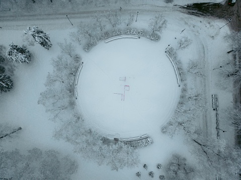 An aerial view of a snow-covered city park