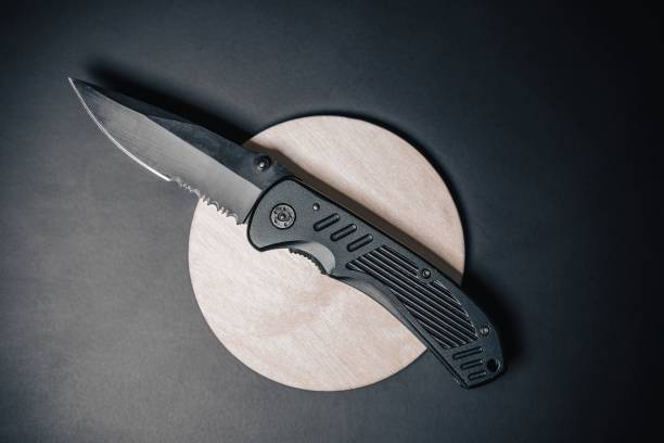 Every day carry pocket folding knife on black background. Close up detail photo of a combat folding knife. Product design photo of an army or SWAT knife. Sharp concealed carry knife. switchblade stock pictures, royalty-free photos & images