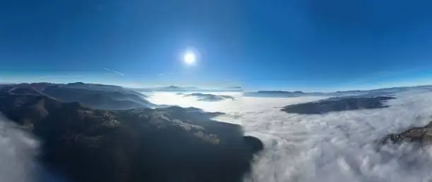Aerial View. Flying over the high mountains in beautiful clouds. Aerial Drone camera shot. Air pollution clouds over Sarajevo in Bosnia and Herzegovina. Hi quality 4K footage.