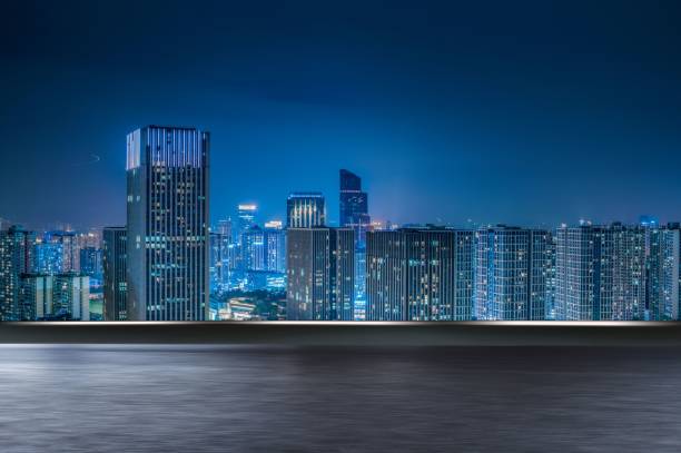 istock motion blurred asphalt road and modern cityscape at night. 1460464685
