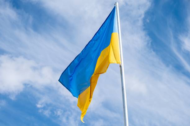 istock Ukrainian flag fluttering in the wind on a white cloudy sky day. 1460467050
