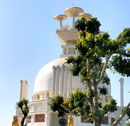 An exterior view of Shanti Stupa of Dhauligiri in Dhauli, India on a bright, sunny day