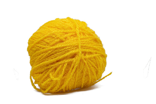 A closeup of a yellow woolen yarn isolated on a white background