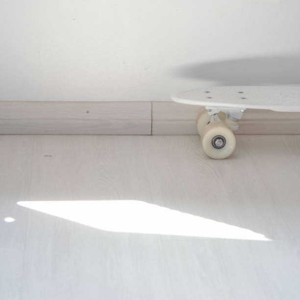 istock Part of white skateboard under a wall with a sunlight 1460470259