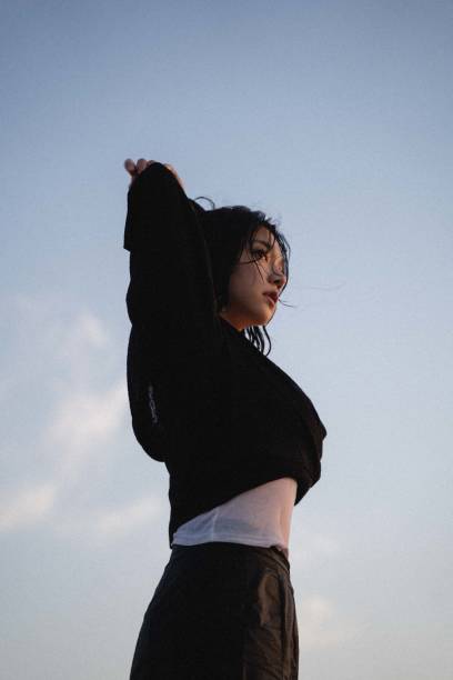 istock Attractive South Korean female with raised hands 1460470535