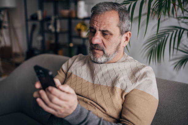 istock The senior is home alone, typing on his smartphone 1460473888
