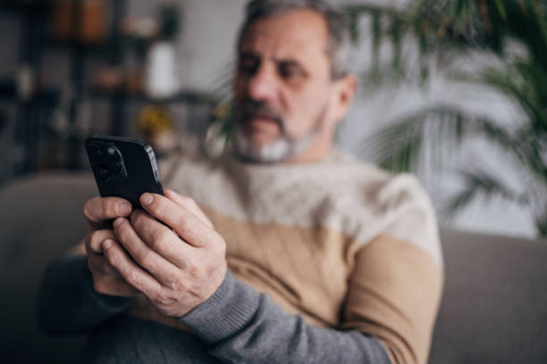 istock The senior is home alone, typing on his smartphone 1460473893