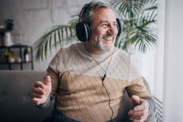 istock Senior with headphones on his head 1460474174