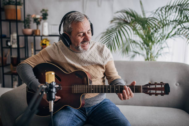 istock Musician with guitar in home studio 1460474215