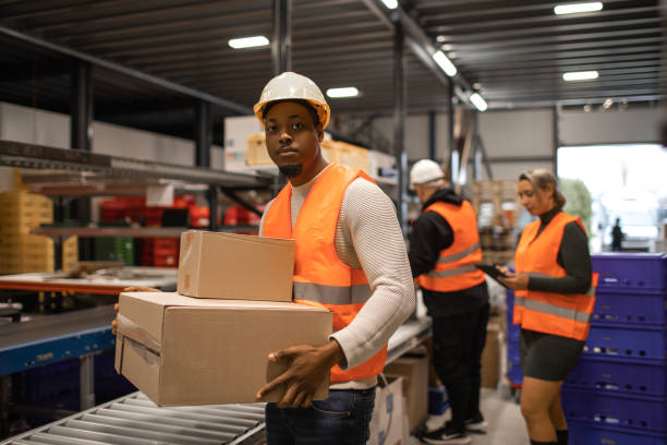 istock Three warehouse workers on a packing and delivery production line 1460477245