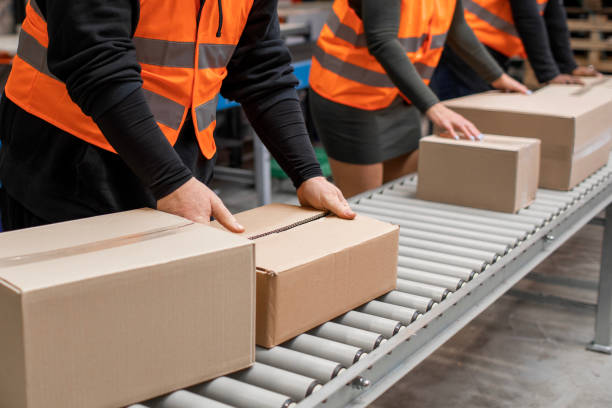 istock Three warehouse workers on a packing and delivery production line 1460477962