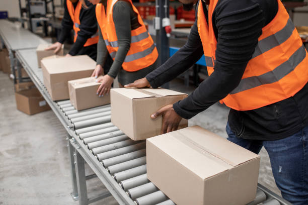 istock Three warehouse workers on a packing and delivery production line 1460477992