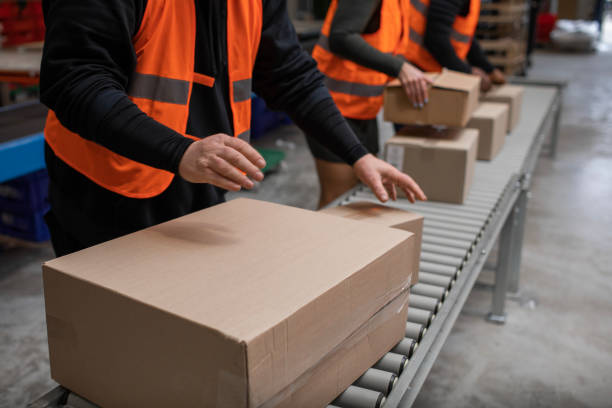 istock Three warehouse workers on a packing and delivery production line 1460478761